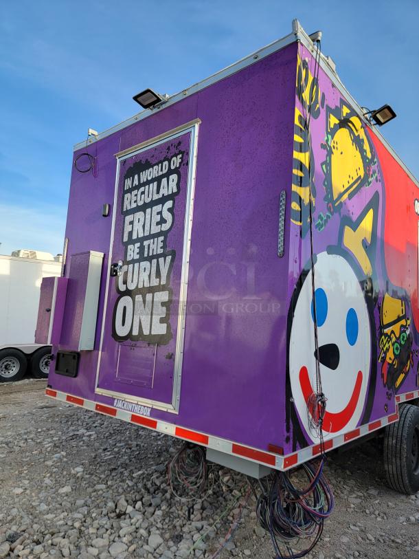 Purple Jack in the Box food truck with branding graphics and slogan. Features exterior lighting and visible wiring at the base.