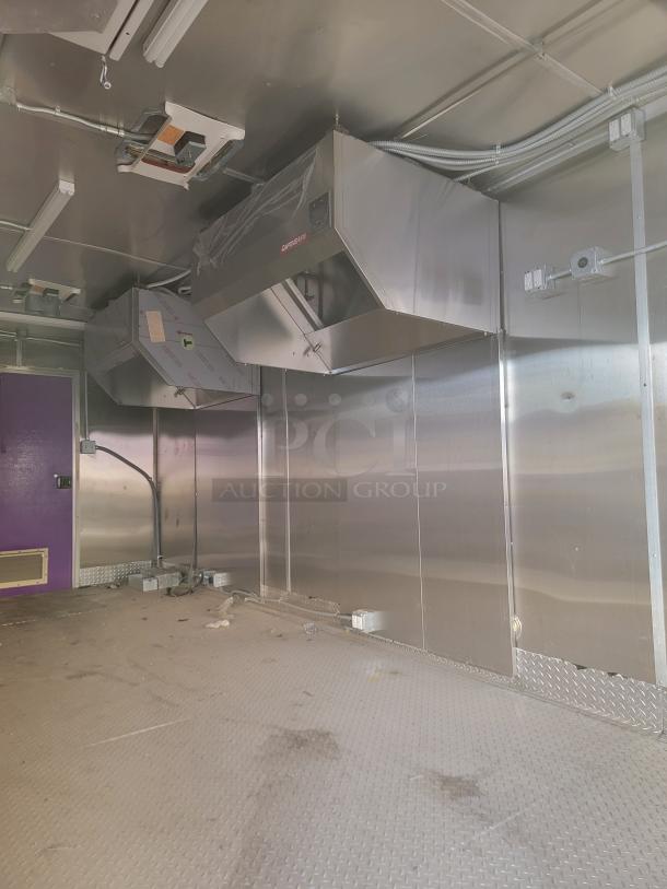 Commercial kitchen with stainless steel range hood, ductwork, and diamond plate flooring. Used condition, minor wear visible.