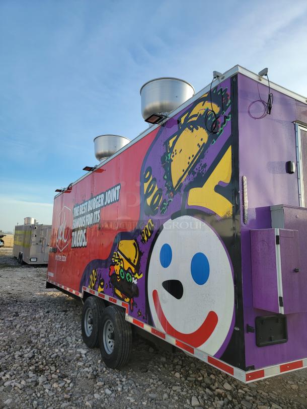 Red and purple food truck with "Jack in the Box" themed graphics, dual axle, rooftop ventilation, on gravel lot.