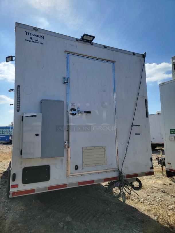 Titanium Cargo Trailer, white with rear door, exterior equipment panel, and visible locks. Good condition.