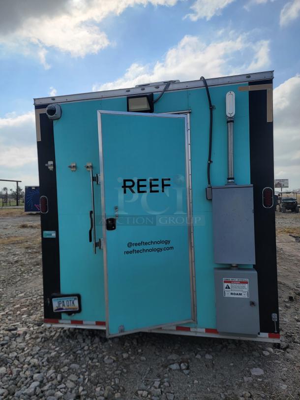 Mobile trailer by Reef Technology, aqua color, closed door, electrical panel. Visible tags: @reeftechnology, reeftechnology.com.