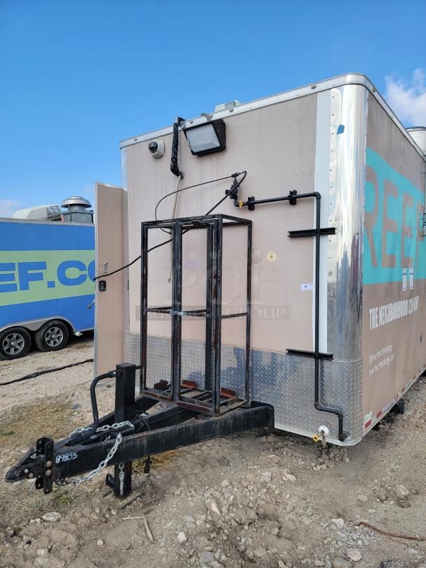 Mobile food trailer with exterior metal frame, hitch, and attached equipment. "REEF" branding visible. Good condition.