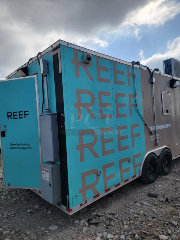 Mobile kitchen trailer by REEF, aqua and gray with branding. Dual axle, mounted equipment. Good condition.