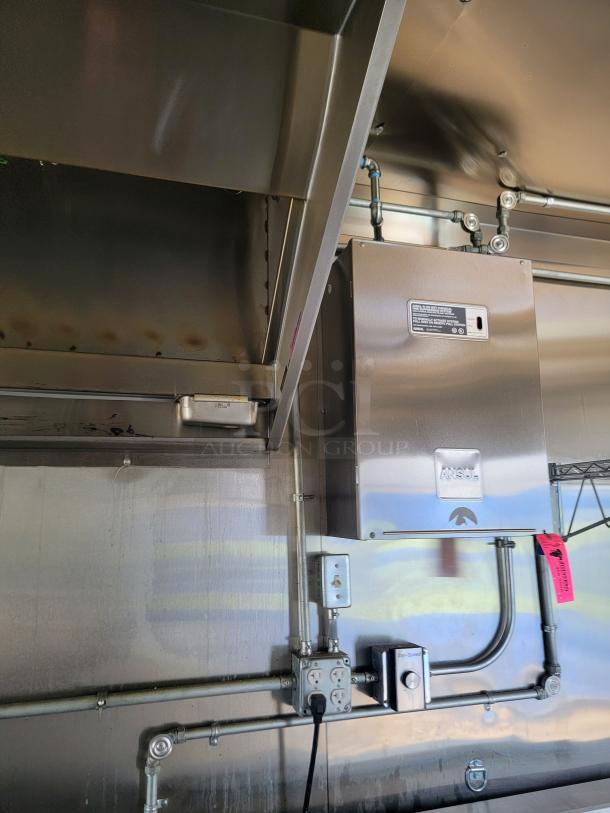 Industrial ventilation system with ANSUL unit, stainless steel construction, visible wiring, and electrical outlets. Perfect for commercial kitchens.