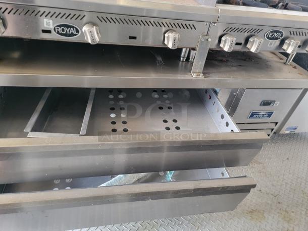 Stainless steel Royal commercial kitchen equipment with control knobs and open drawers, showing air vents and storage.