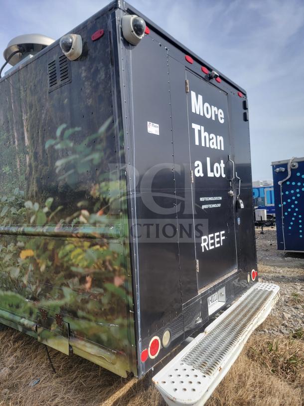 2013 Freightliner MT45 mobile kitchen, Utilimaster body, "More Than a Lot" and "REEF" signage, rear view.
