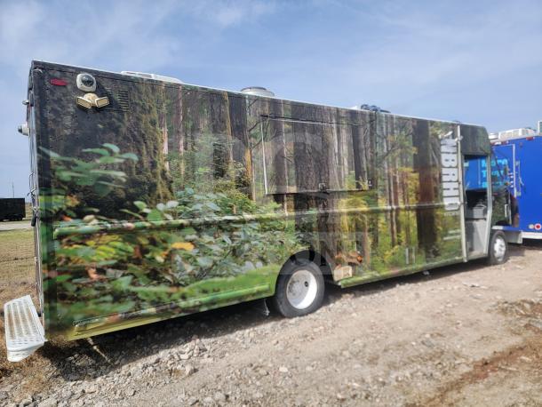 2013 Freightliner MT45 mobile kitchen truck with Utilimaster body, forest-themed wrap, featuring Arctic Air refrigeration.
