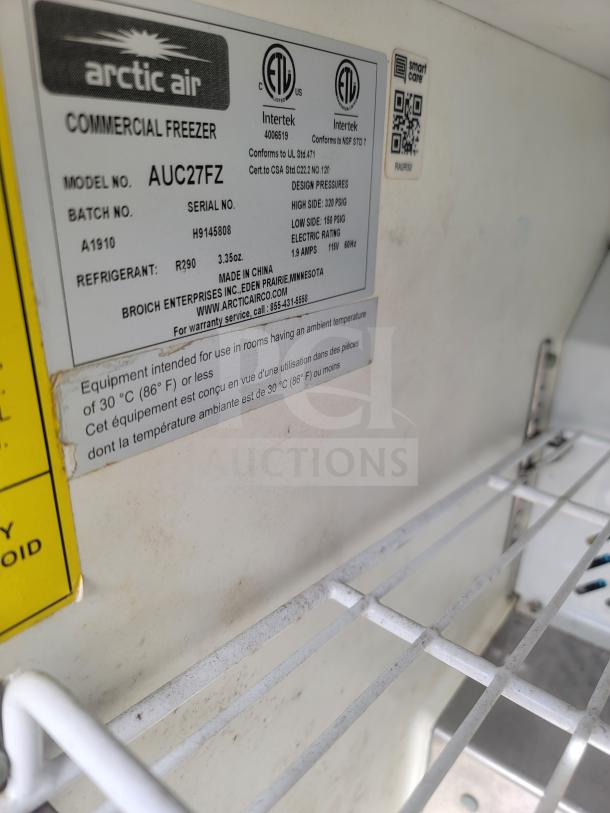 Arctic Air Commercial Freezer model AUC27FZ label with specs; 115V, 1.9A, refrigerant R290, conforms to UL and NSF standards.