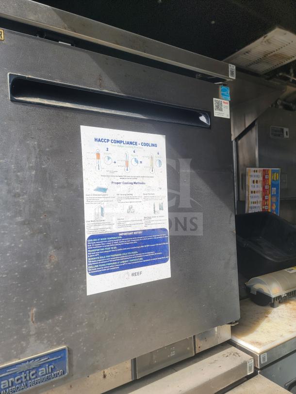 2013 Freightliner MT45 mobile kitchen featuring Arctic Air refrigeration and Hoodz ventilation; visible HACCP compliance guide.