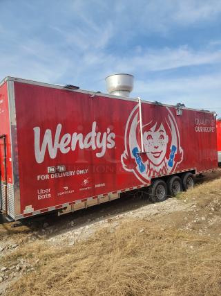 Red Wendy's food truck trailer with branding, "For Delivery Only," featuring Uber Eats, DoorDash, Postmates, Grubhub logos.
