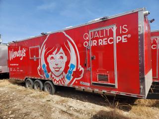 Red Wendy's food trailer with logo and "Quality Is Our Recipe" text, three axles, delivery-only markings, and vent.