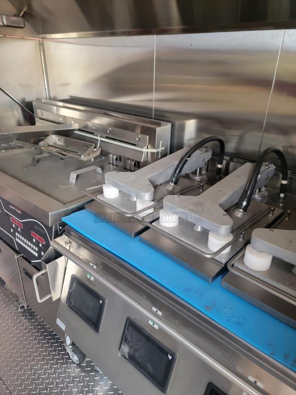 Commercial kitchen equipment with stainless steel components, dual heating elements, and digital controls. Used condition with visible wear.