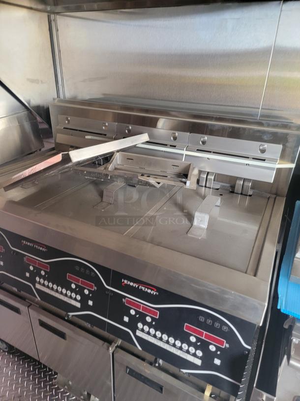Henny Penny commercial fryer, dual compartments, digital control panel, stainless steel, gently used, ideal for kitchens.