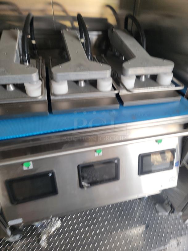 Commercial-grade food preparation equipment with two sections, control panels, and stainless steel finish. Appears in good condition.