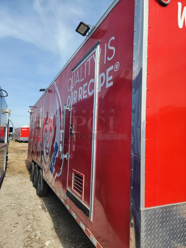 Red food truck with Wendy's branding, featuring "Quality Is Our Recipe" text. Image shows side view with vent and door.