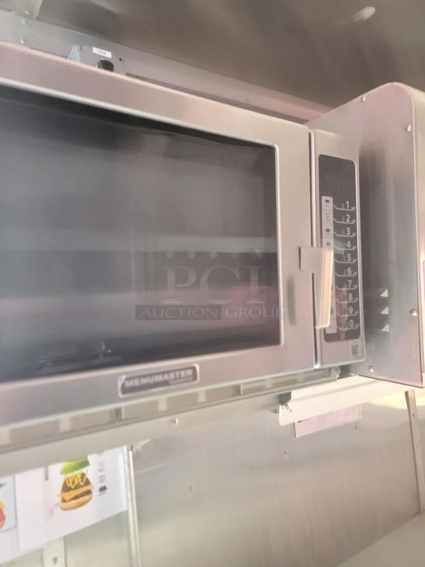 Menumaster microwave oven, stainless steel, featuring keypad with number settings. Appears in good condition.