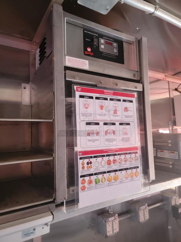 Commercial warming station with Wendy's branding, stainless steel, control panel, and procedure sheet.