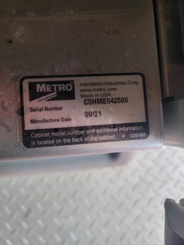 Metal appliance with Metro label showing serial number C5HME042580, made in USA. Manufacture date: 09/21.