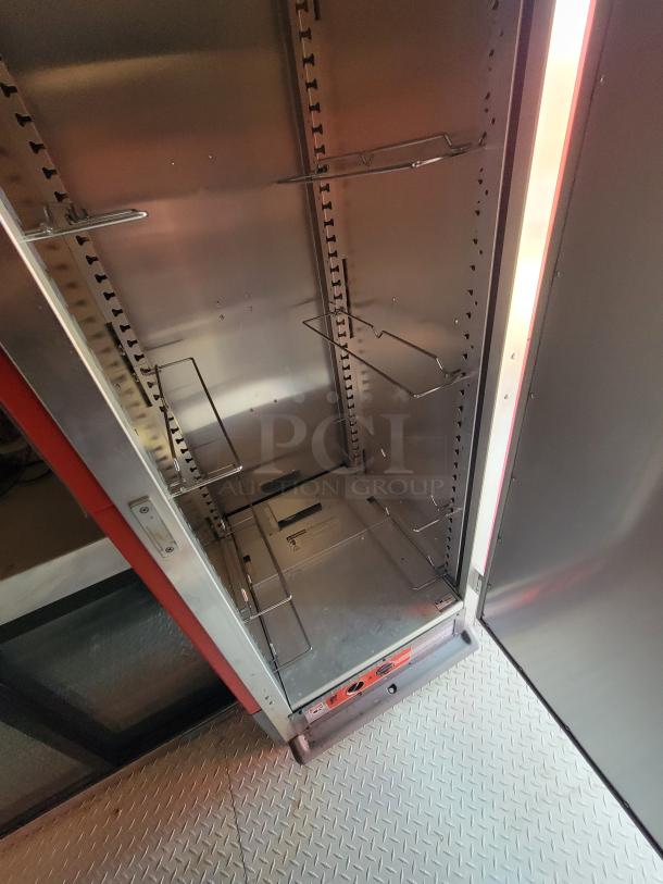 Stainless steel storage cabinet with adjustable wire racks and visible vent panel. Good condition, suitable for kitchen or industrial use.