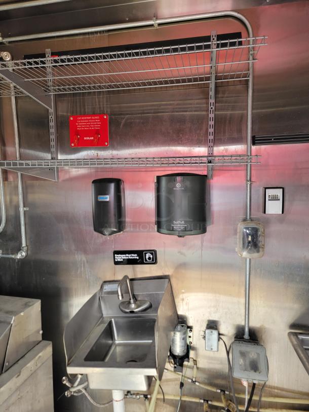 Stainless steel handwashing station with Gojo soap and SofPull towel dispensers, Ecolab safety sign, and utility hookups.