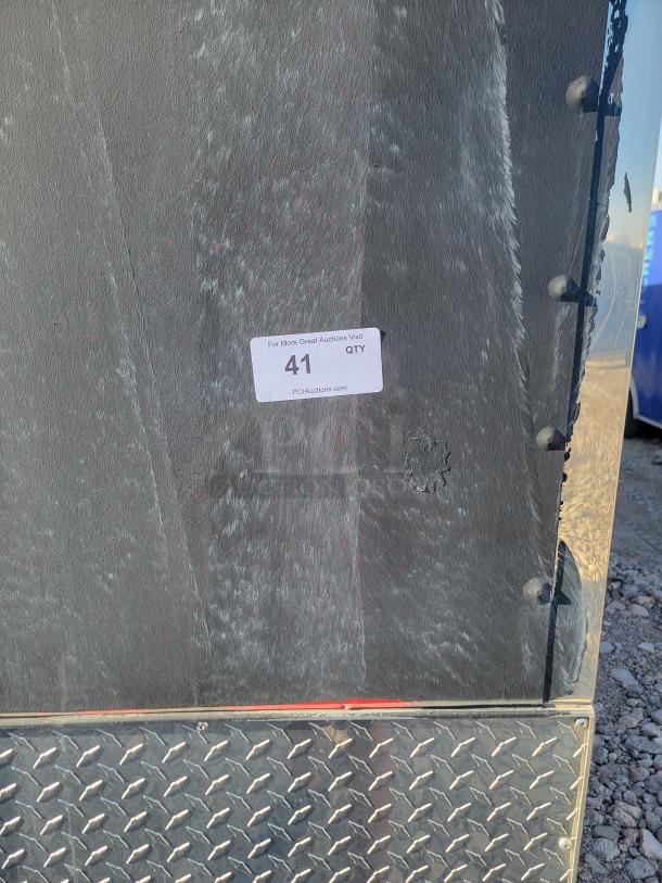Metal surface with a diamond plate pattern; a sticker labeled "41 QTY" from PCI Auctions is visible, indicating auction information.