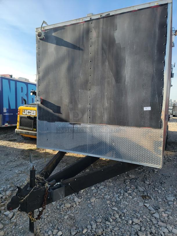 Utility trailer with black sides, diamond plate trim, and visible wear. Includes hitch, security camera mount, and label marked "41."