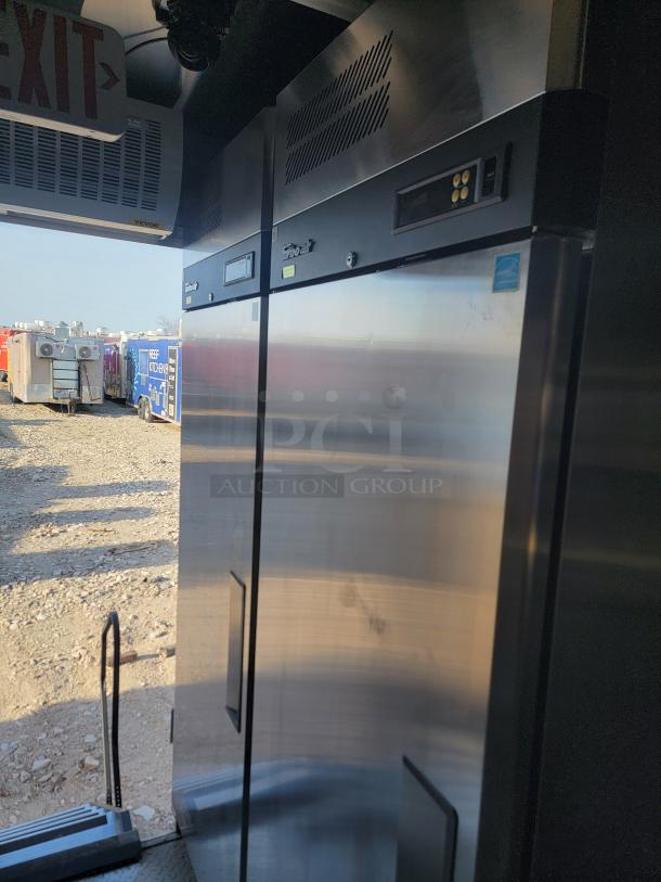 Steel commercial refrigerator, stainless finish, True model T-49, digital controls, minor surface wear, auction setting.
