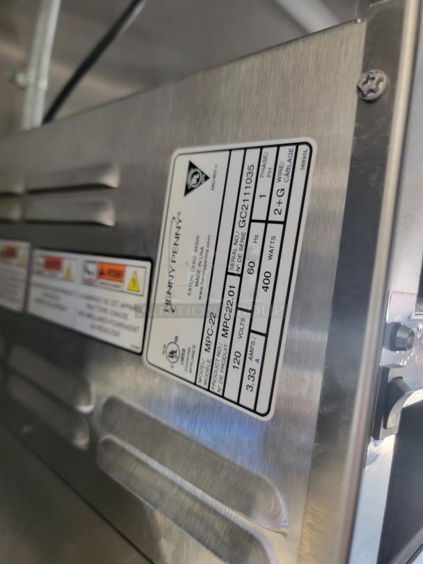 Heavy-duty stainless steel appliance with service label. Markings indicate brand as Henry Penny, model MPC-22. Serial GC211105. 120V, 400W.