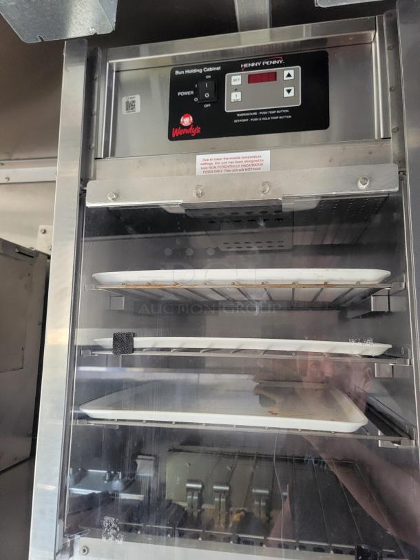Henny Penny bun holding cabinet with trays, Wendy's logo, digital controls. Suitable for non-potentially hazardous food.
