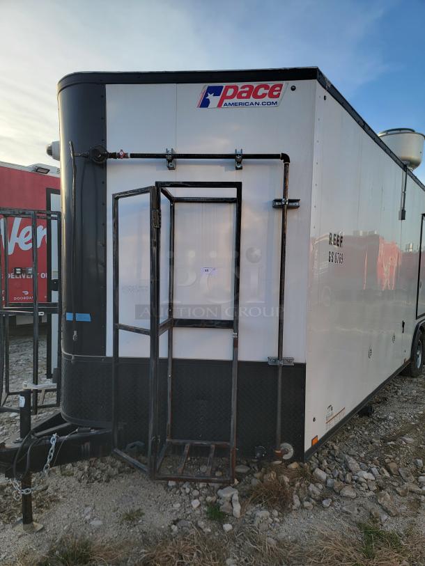 Pace American trailer, white and black, with reinforced front cage. Branding visible, in used condition. Model REEF GS 8789.