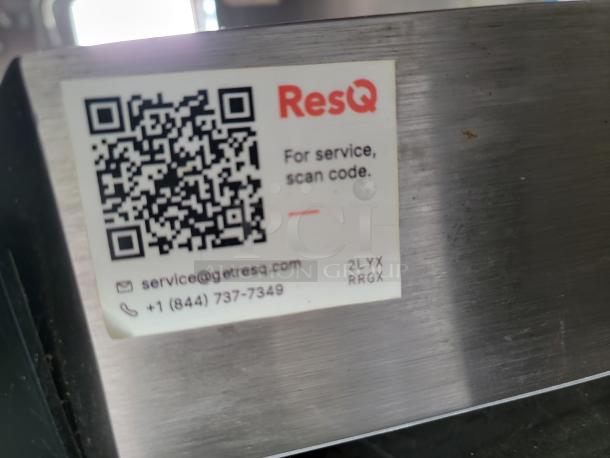 Silver device with ResQ service label, showing a QR code, an email, phone number, and service code "2LYX RRGX."