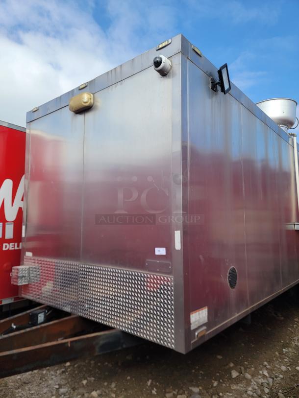 Large metal storage container with diamond plate lower panel, security camera, and exterior lights. Good condition.