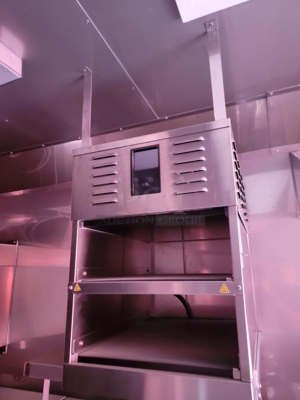 Stainless steel commercial oven with ventilation slots and viewing window, in good condition. No visible brand or model markings.