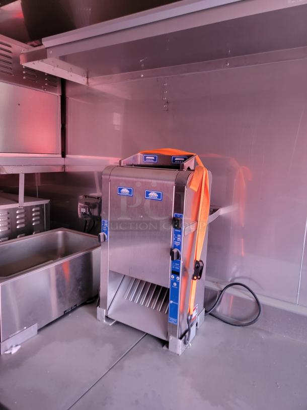 Commercial-grade Hobart bread slicer, stainless steel, excellent condition, features adjustable settings and safety guards.