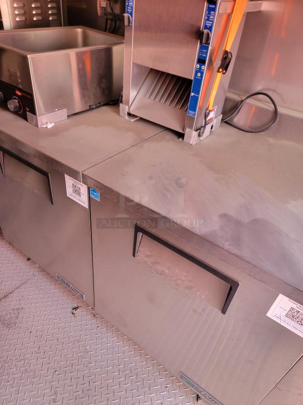 Commercial stainless steel kitchen equipment with drawer handles, visible control panel, and QR code labels. Good condition.