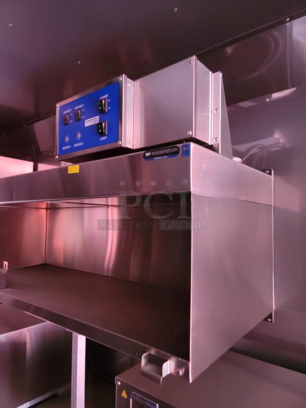 Stainless steel commercial kitchen hood with controls; Wasserstrom label; used condition.