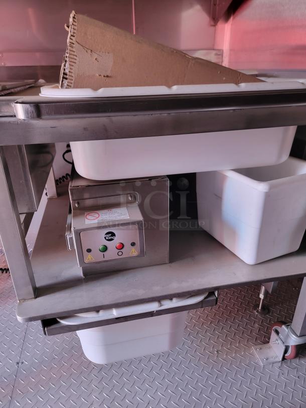 Alt text: Stainless steel commercial cart with Ayr King control panel, containing white storage bins and cardboard.
