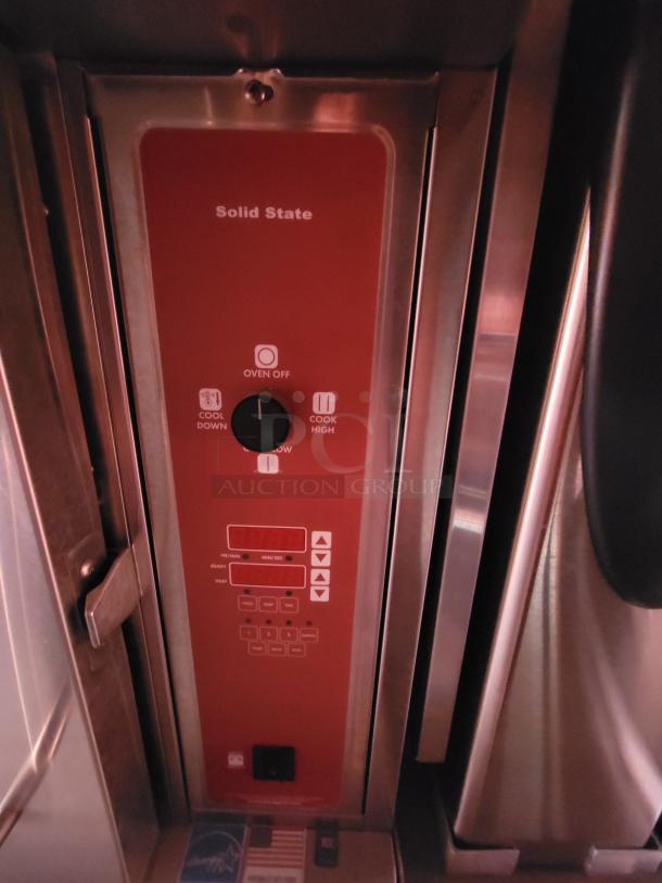 Industrial oven control panel with "Solid State" label, indicating cool down and cook settings. Stainless steel casing.