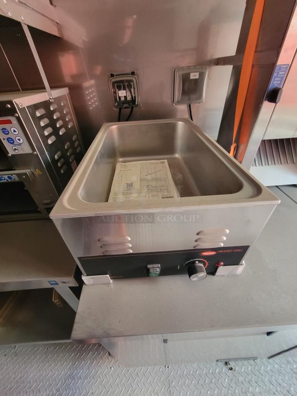 Commercial heated well with temperature dial, stainless steel construction, includes user manual, good condition.