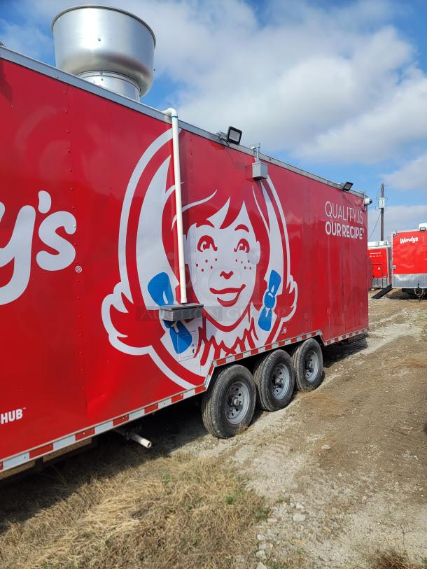 Red Wendy's food trailer with logo, three wheels, exhaust vent, and "Quality is Our Recipe" text. Good condition.