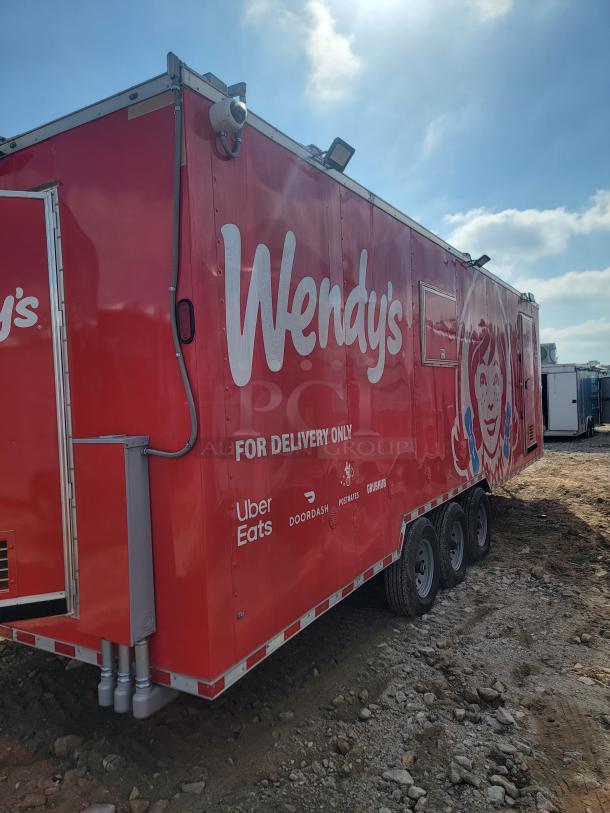 Red Wendy's delivery truck with logos for Uber Eats, DoorDash, Postmates, and Grubhub. Condition appears used.
