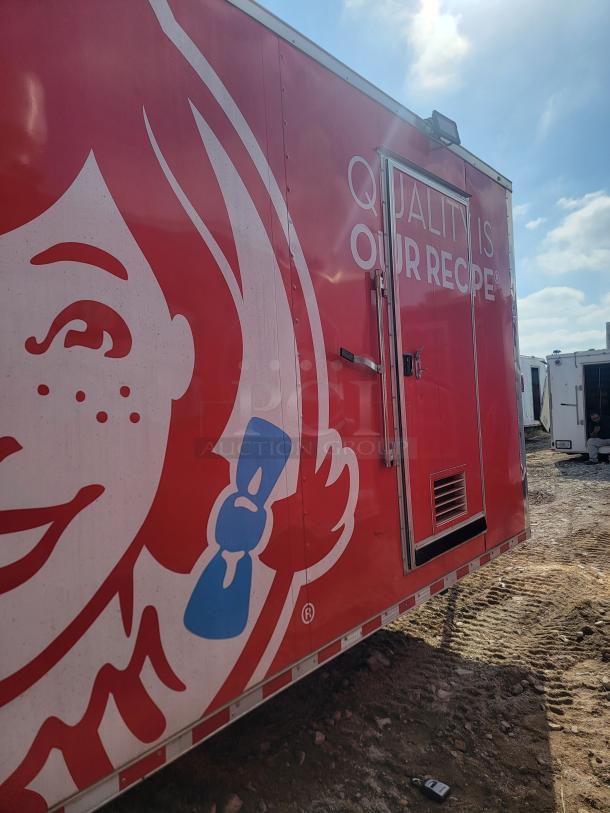 Red food truck with "Quality is Our Recipe" slogan, featuring a large logo. Appears in used condition.