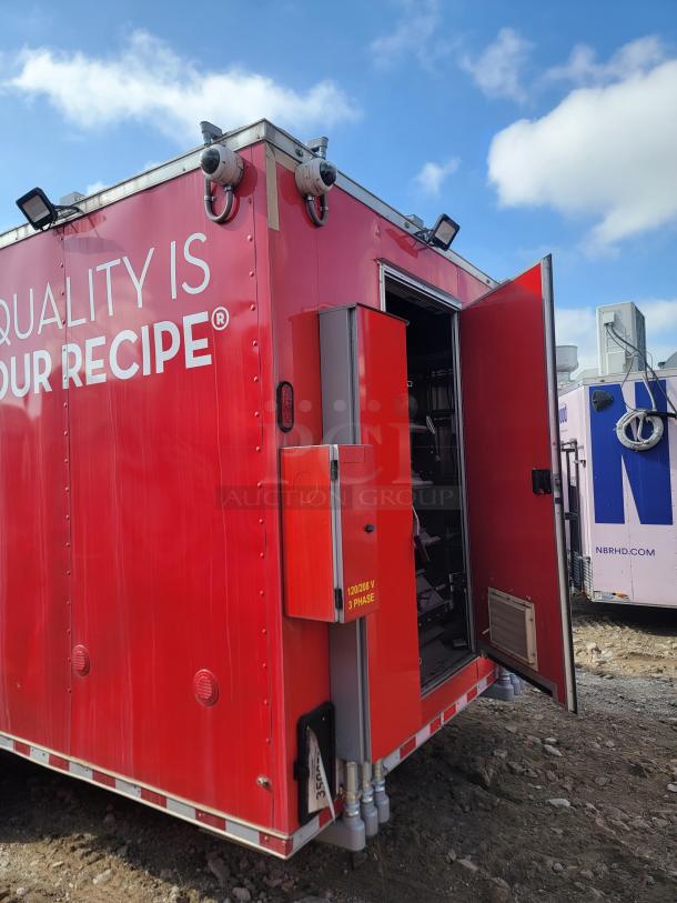 Red mobile unit with open door, security cameras, and industrial power panel labeled "120/208 V 3 Phase." Bold lettering reads "QUALITY IS OUR RECIPE®."