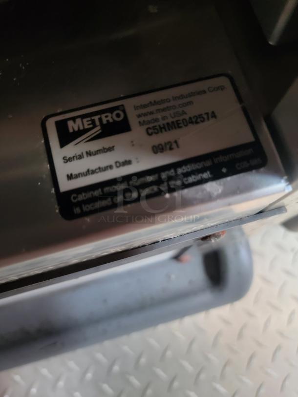 Metro cabinet label showing serial number C5HME042574, manufactured 09/21, by InterMetro Industries Corp, USA.