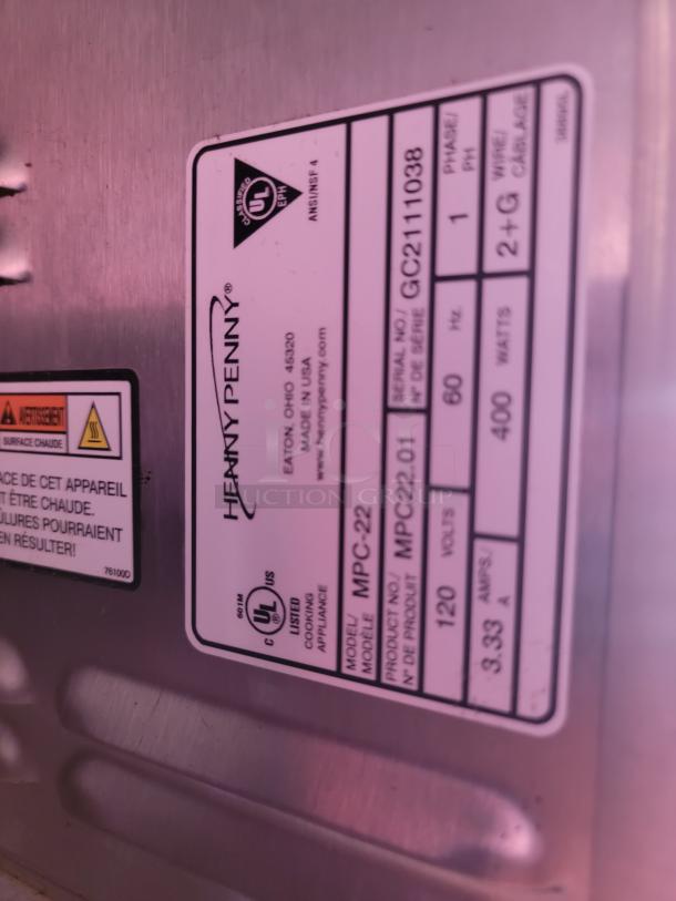 Henry Penny cooking appliance label showing model MPC-22, serial GC211038. UL listed, 120 volts, 400 watts, made in USA.