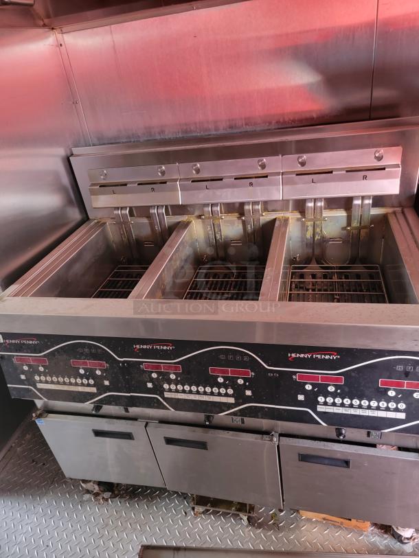 Henny Penny commercial deep fryer with dual compartments; stainless steel; digital controls; used condition.