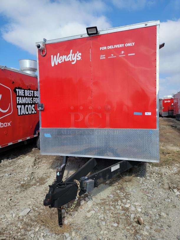 Red Wendy's delivery trailer with logos for Uber Eats, DoorDash, Postmates, and Grubhub. Metal base, hitch visible.