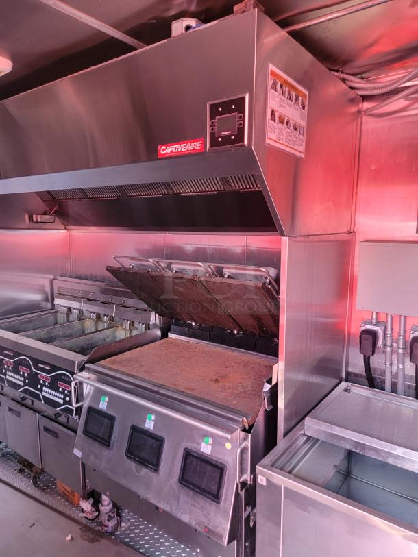 CaptiveAire commercial kitchen ventilation hood system, stainless steel, used condition, visible grease residue, model unknown.