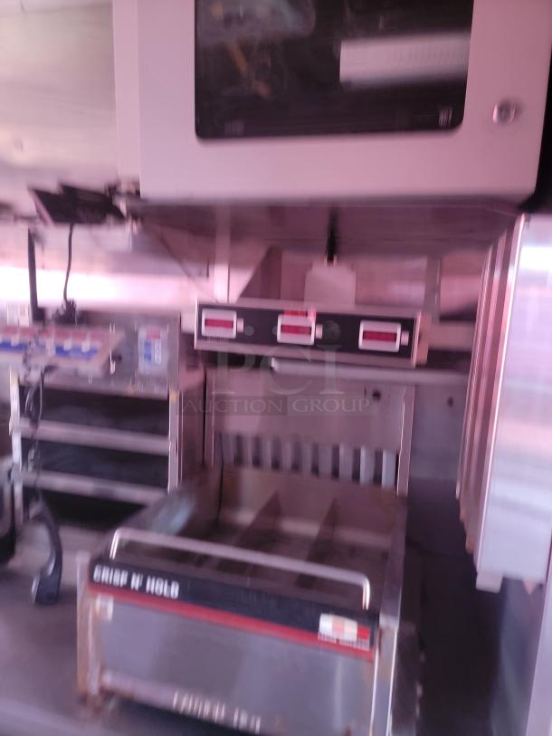 Commercial kitchen equipment featuring a Crisp N Hold food storage unit, stainless steel, moderate wear visible.