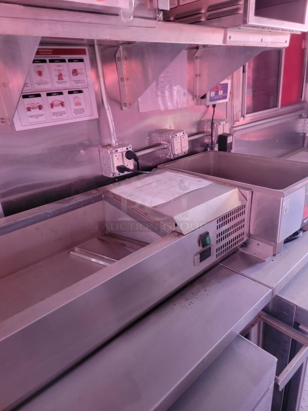 Stainless steel commercial food warmer with temperature control, instruction labels visible, good condition.